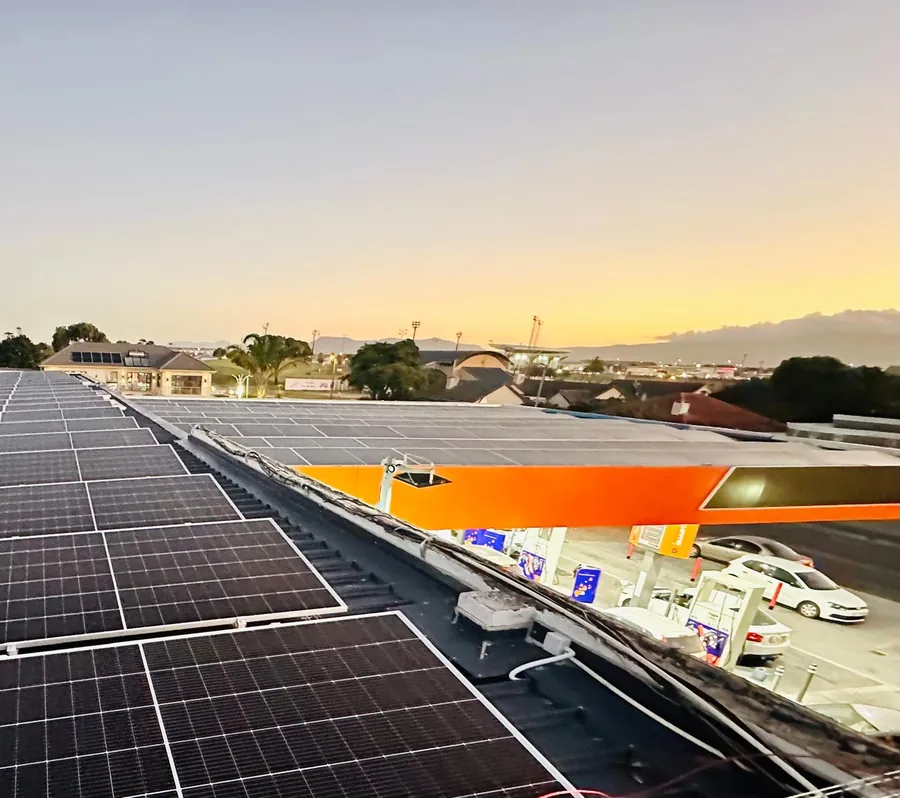 Commercial rooftop solar installation above an Astron Energy fuel station forecourt