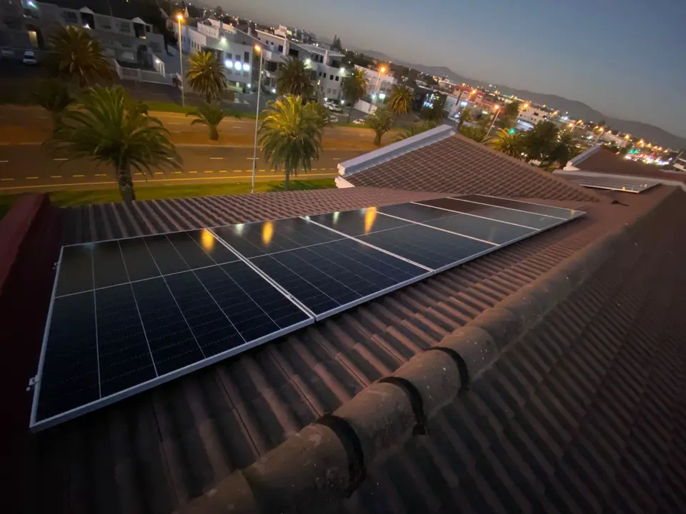Rooftop solar panel installation at dusk on a home in Bloubergstrand, Cape Town
